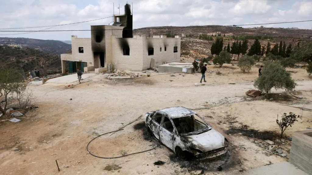 Smoke rises from homes after a settler attack in Jalud, West Bank