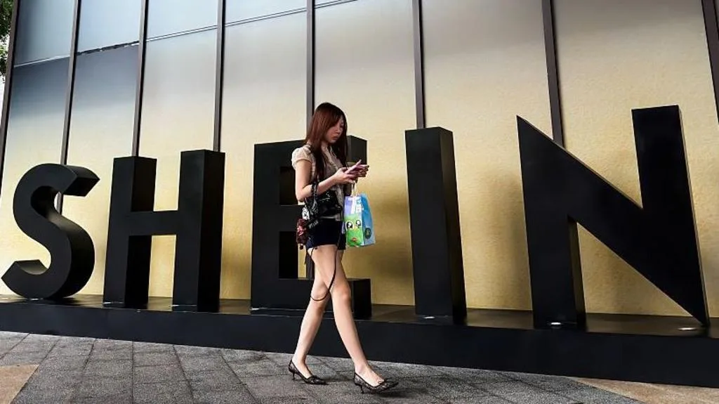 Shein logo and stock market chart during Hong Kong IPO debut
