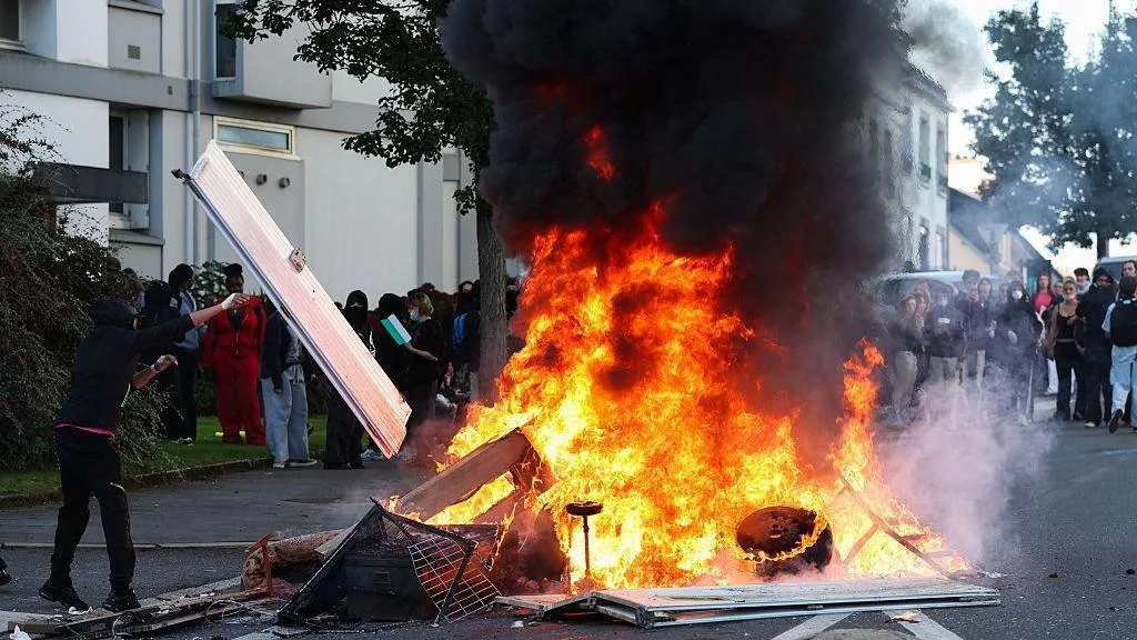 Students protesting outside a school in France as police respond