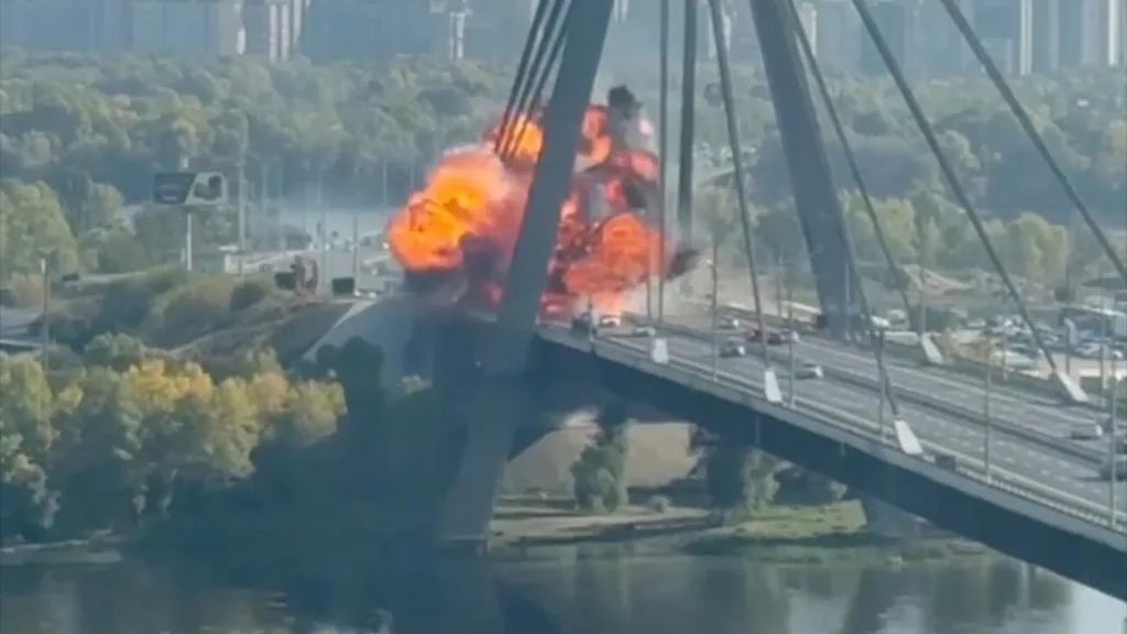 Smoke rises from a damaged bridge in Kyiv after a Russian drone strike