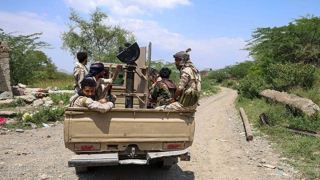 Yemeni forces and Houthi fighters amid the country's widening war