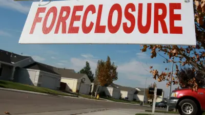 Family reviewing finances over unpaid HOA fees and foreclosure risk in Michigan