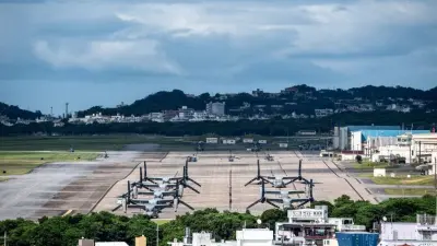 Police and officials in Okinawa following the hotel death investigation